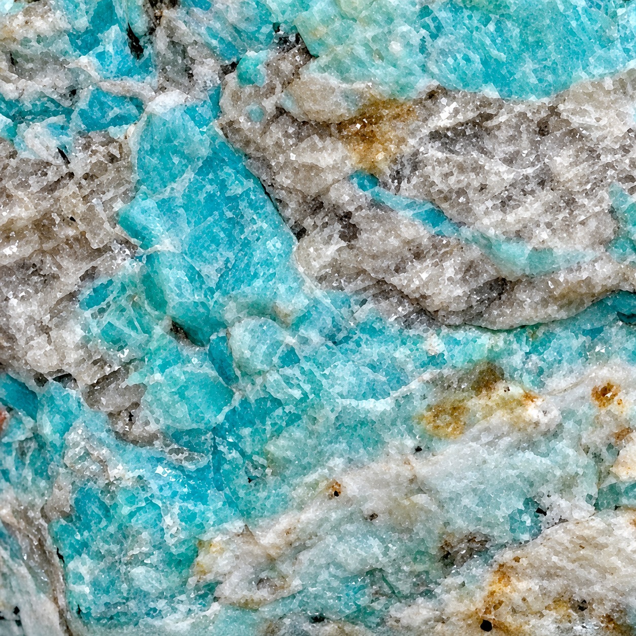 Close-up of blue-green amazonite showing blocky feldspar texture and pale mineral matrix
