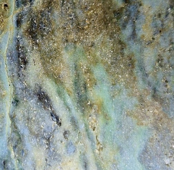Close-up of Obay stone showing blue-green, pale and brown colour variation in Golden Bay polychrome schist